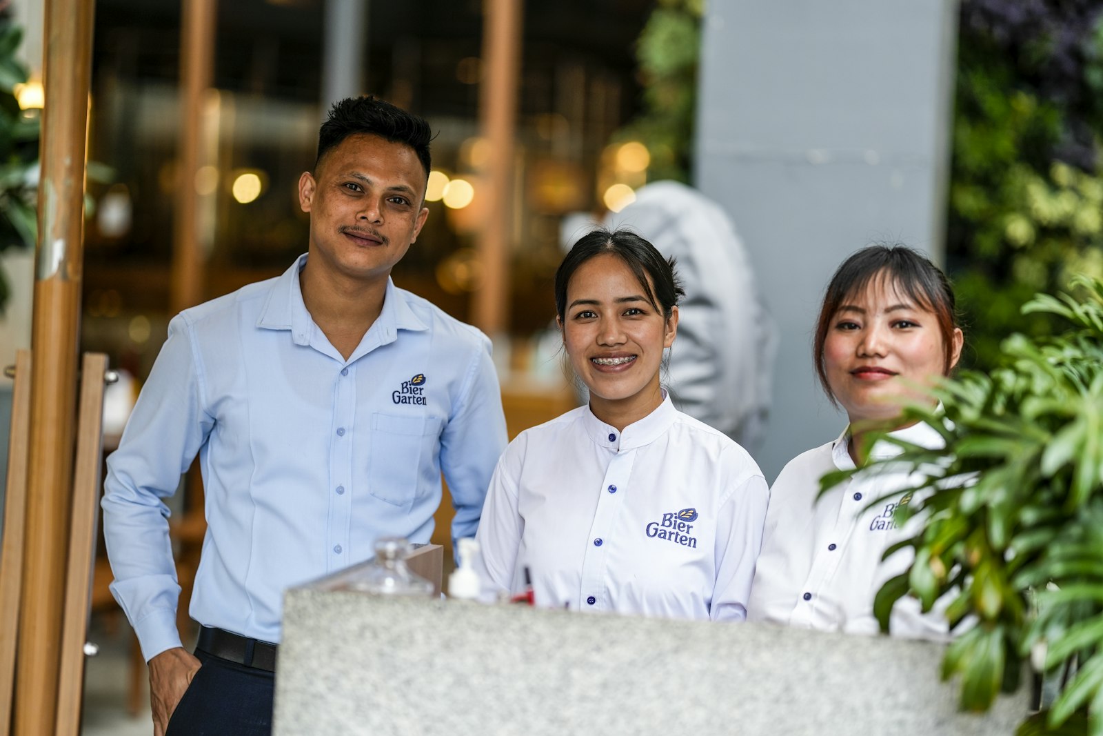 Three smiling restaurant staff