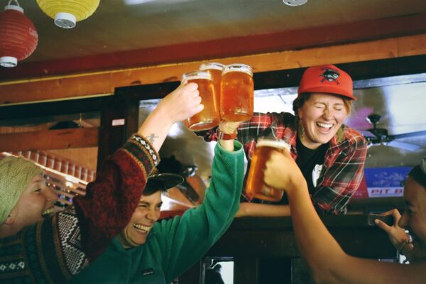 People cheering with mugs