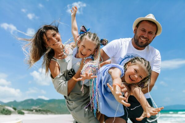 Happy family taking a beach selfie