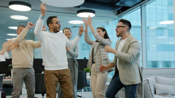 Team clapping and dancing together as they celebrate