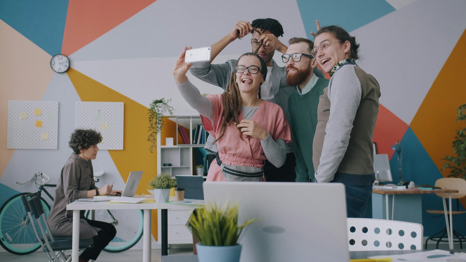Friends laughing while taking a selfie on a smartphone