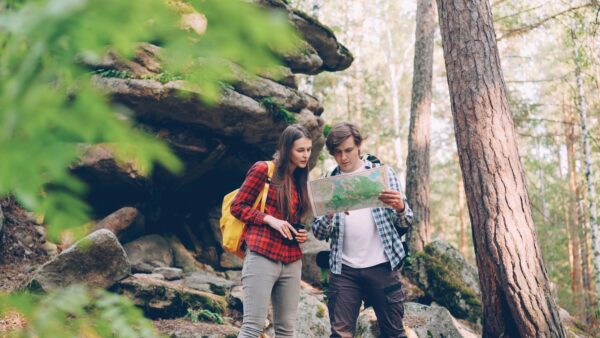 Couple looking at a map in a forest
