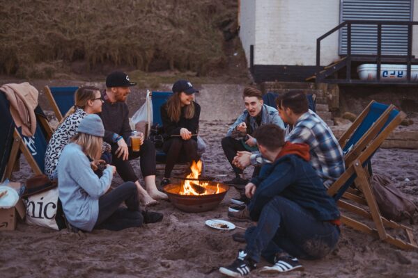 Group of people sitting in front of a firepit