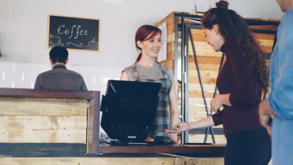 Customer paying for coffee with a mobile phone